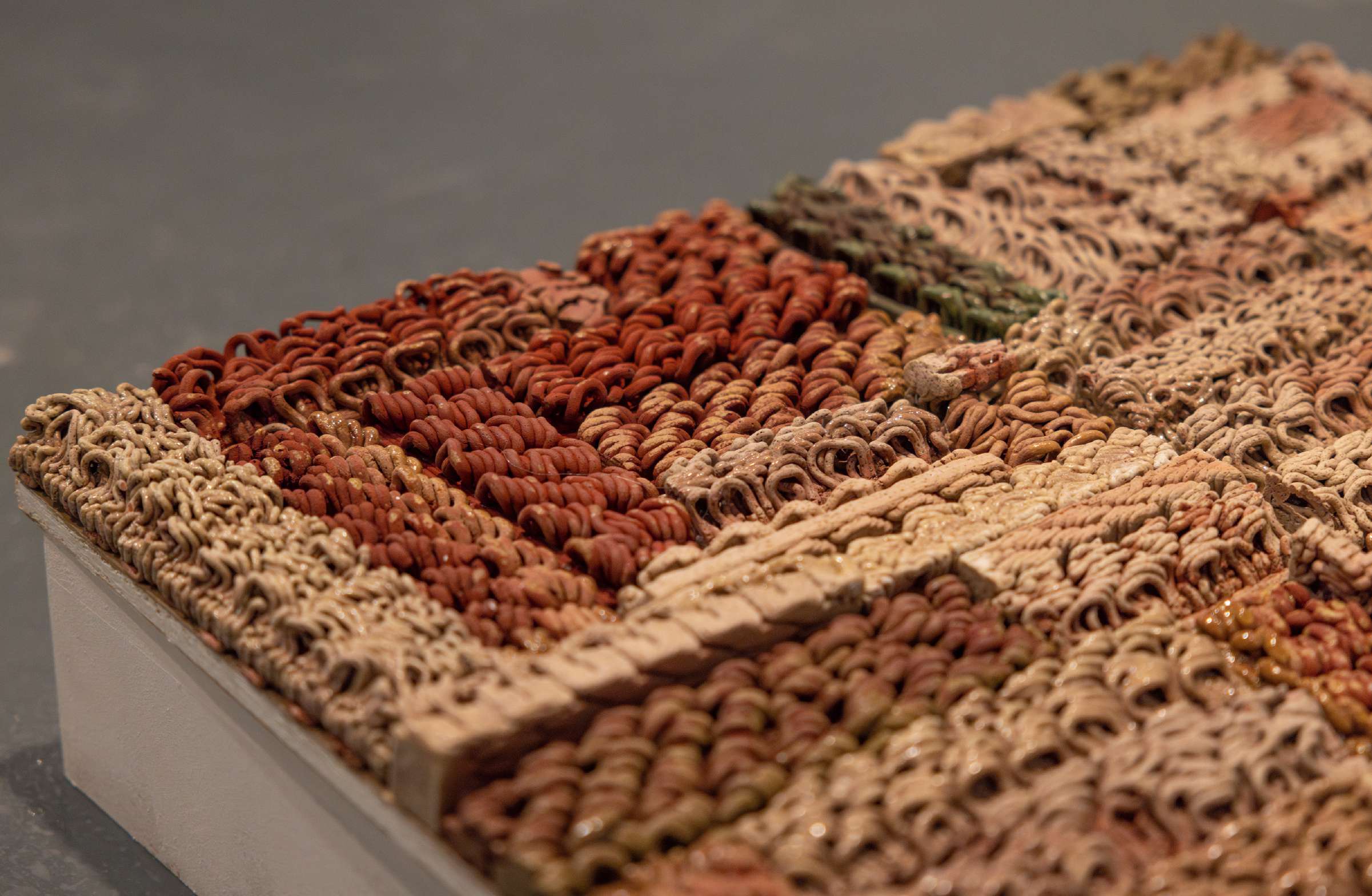Close detail of layered, textile-like strands of Egyptian paste